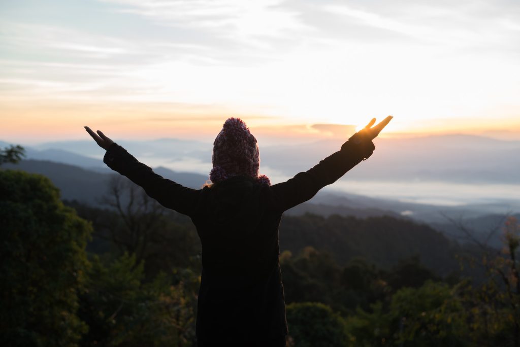 hiking woman enjoy the beautiful view at mountain peak